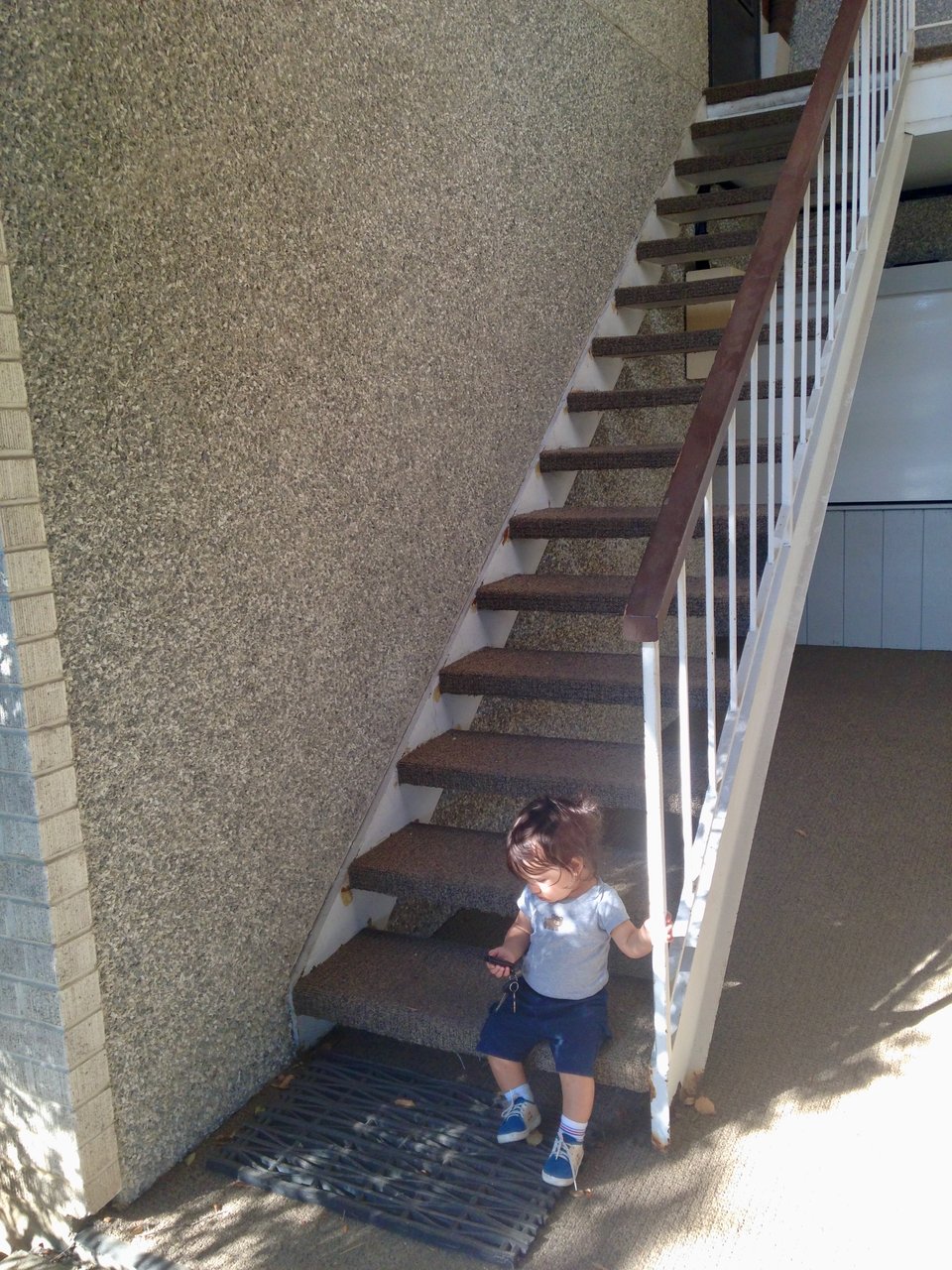 Henry, age 1, on the stairs of our apartment