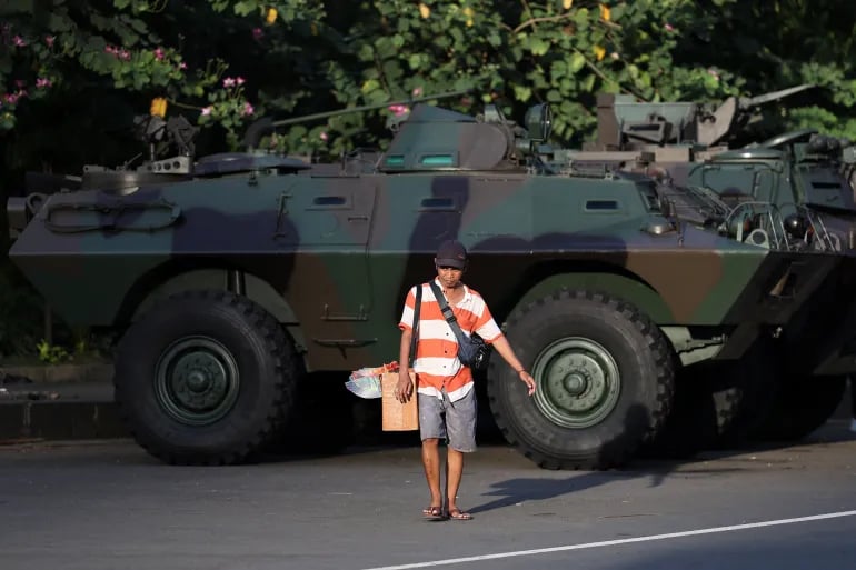 A street vendor walks near an armoured military vehicle parked outside the National Monument (Monas) complex, amid the widespread antigovernment protests in Jakarta, Indonesia, September 2, 2025