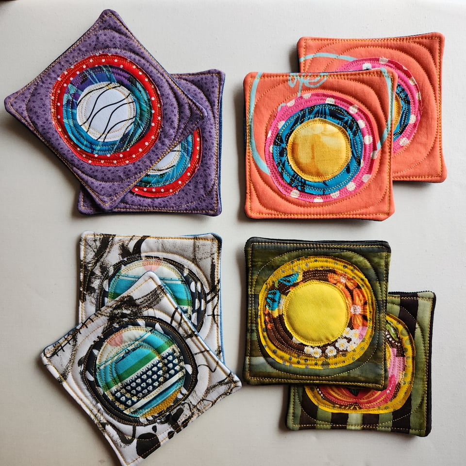 Top-down photo of four sets of fabric coasters made by Sarah Atlee.