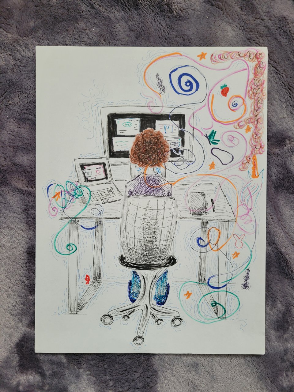 Drawing of a curly-haired person sitting at a computer desk. The person is facing away from us. There are three monitors at their desk, and to the right is a notebook and pen. Swirling around them are multi-colored shapes, unicorns, stars, rabbits, and mushrooms.