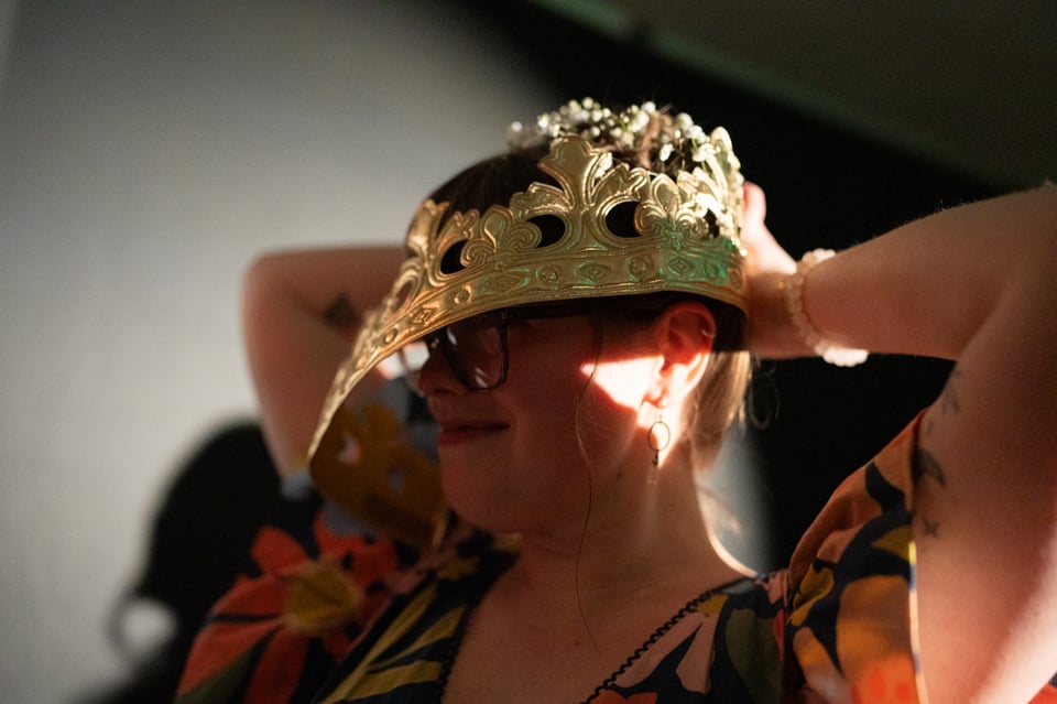 Lizzie putting on her crown.