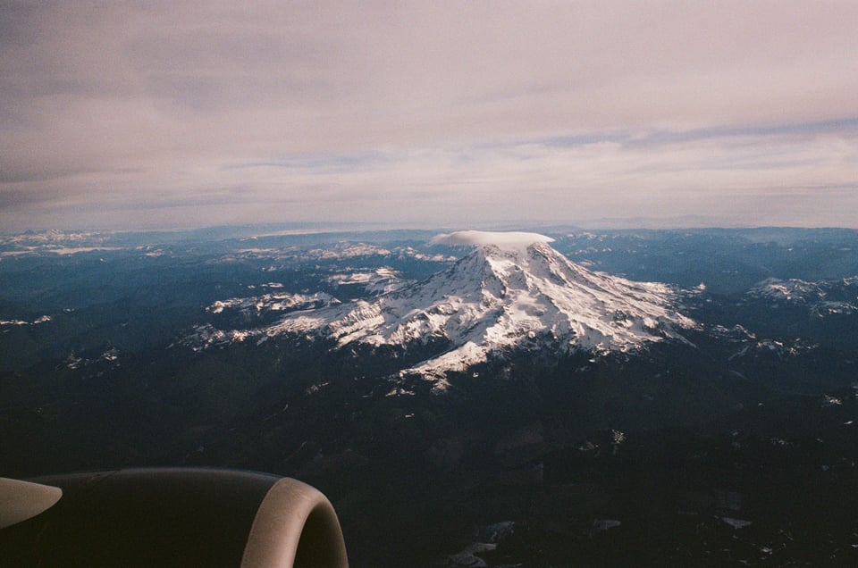 a film photo of mt rainier out a plane window