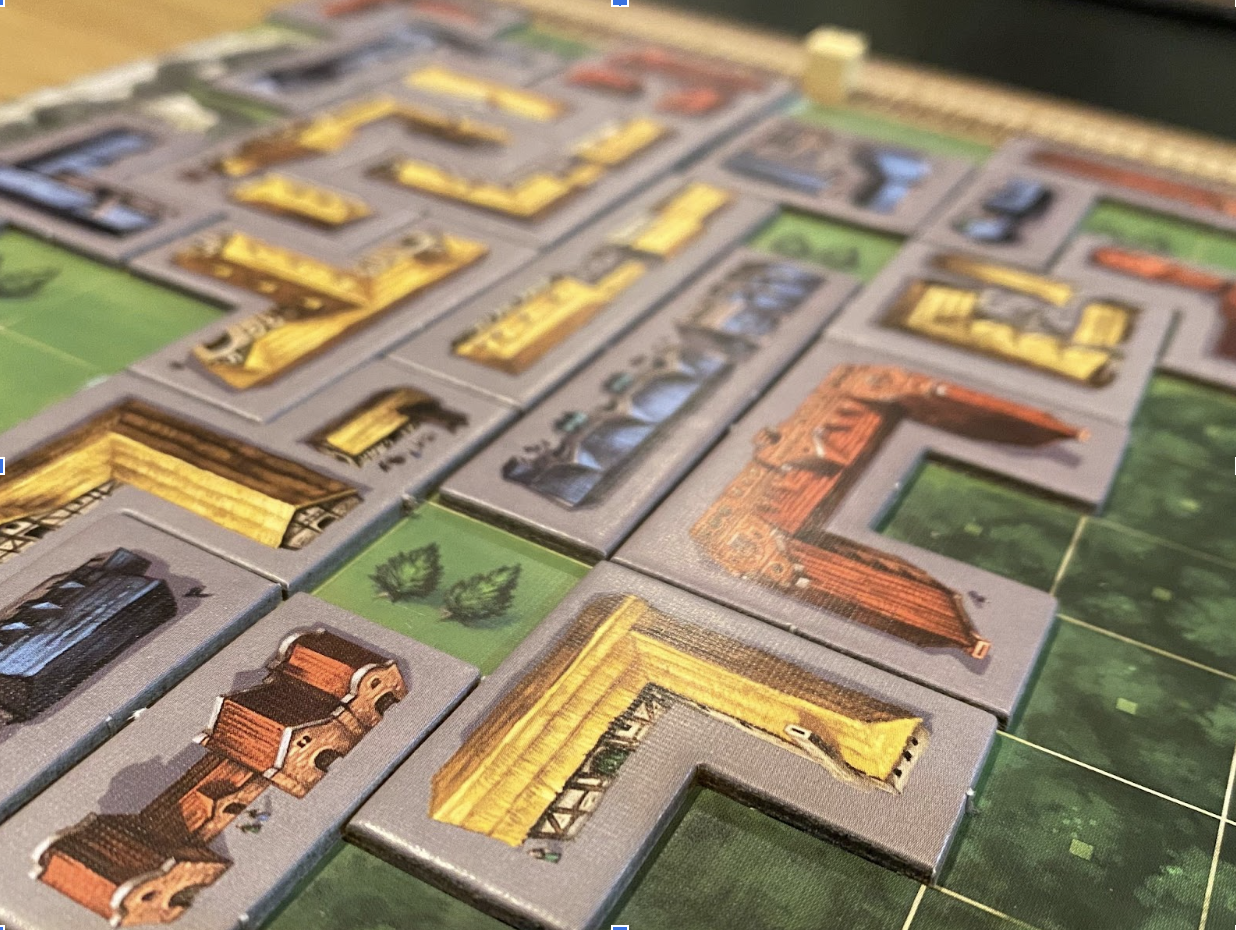 Building tiles from "My City" laid out on a player board.