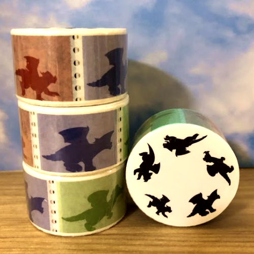 A photo of several washi tape stacked together. The designs are of several dragons running in sequence.