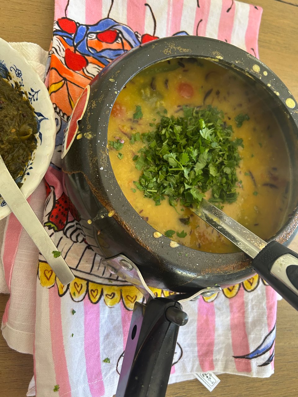 a pressure cooker full of yellow, split pea lentils and topped with cilantro.