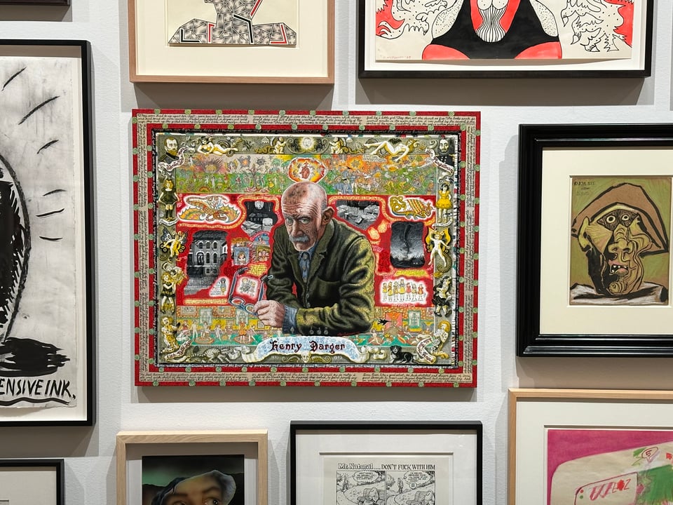 photo of a number of paintings and drawings surrounding Joe Coleman's intricate painting of Henry Darger