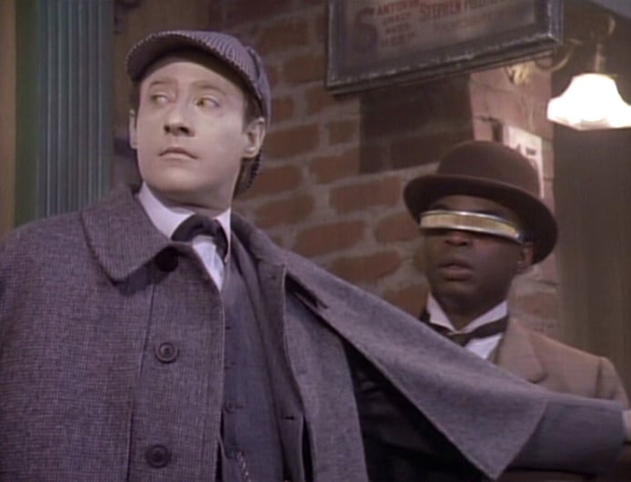 Data dressed as Sherlock holmes holding back Jordy LaForge, from Star Trek Next Generation
