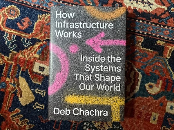 How Infrastructure Works, by Deb Chachra. Not pictured: The (invisible) systems of delivery that brought the book and this 60-year-old rug from western Iran to my door