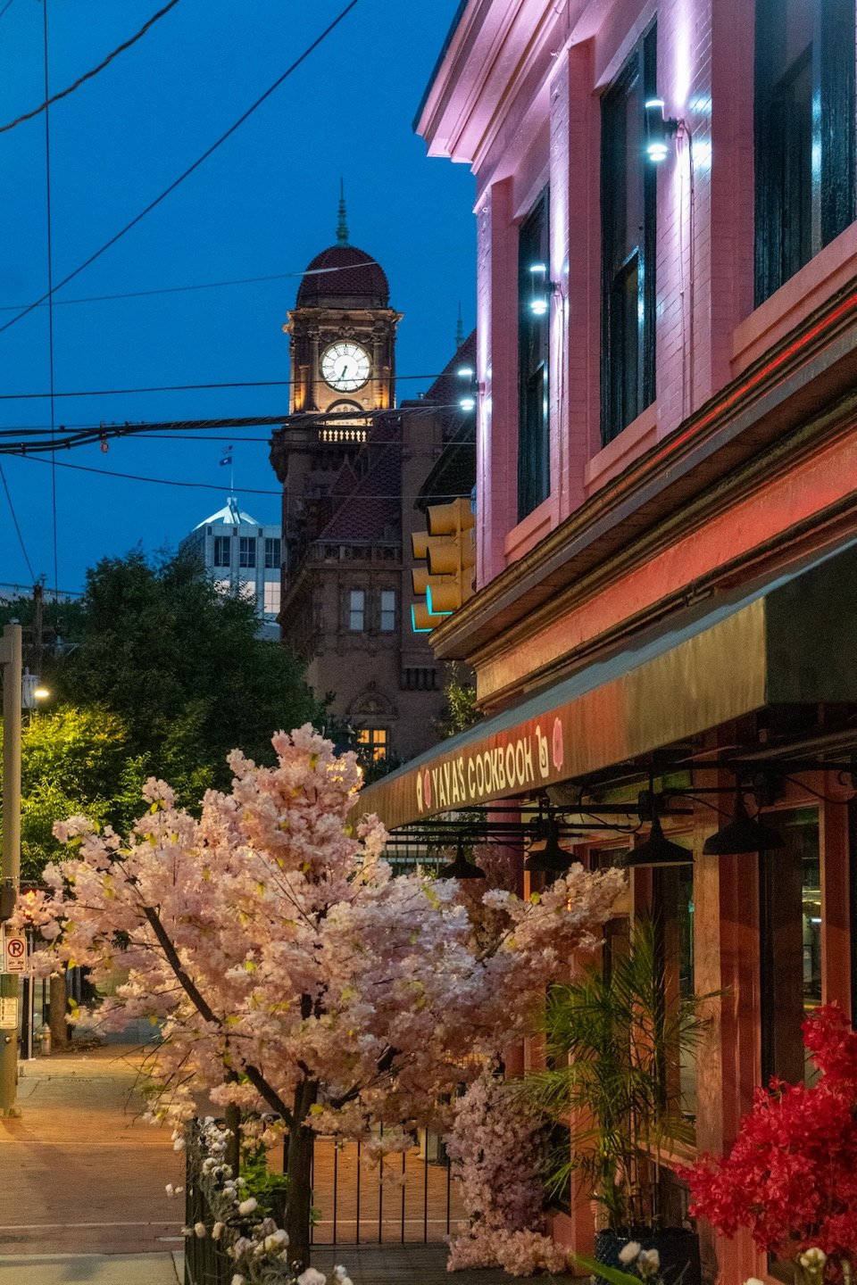 Clock tower of train station and restaurant patio