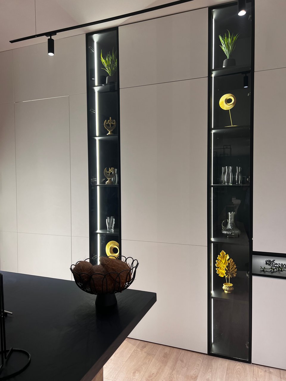 Elegant white paneled walls, with inset lighted cabinets