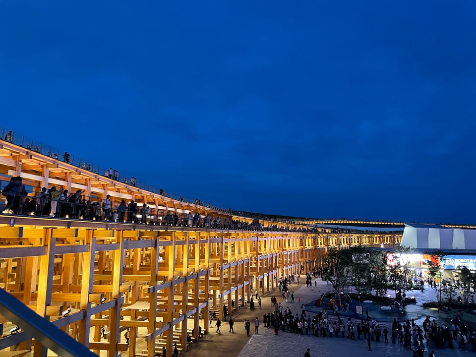 The Osaka Expo ring illuminated at night.