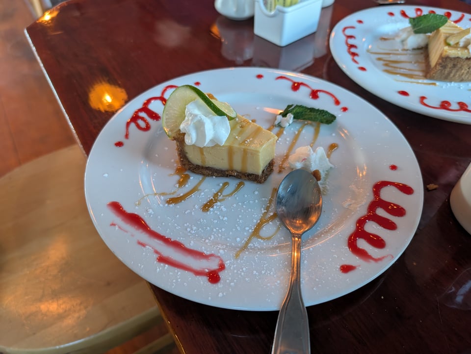 A partially eaten slice of key lime pie