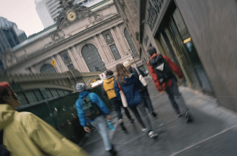 a group walking on the sidewalk in midtown