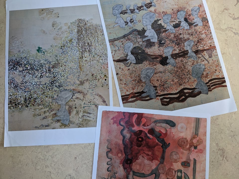 Photo of printouts of three Ellen Gallagher artworks