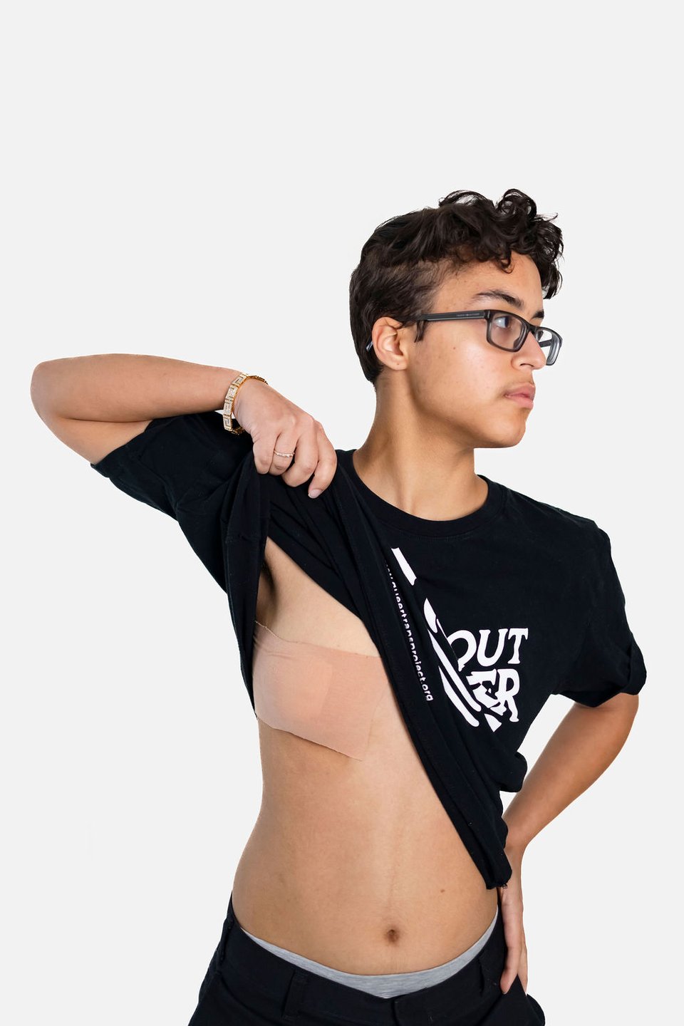 Image of a human lifting their shirt with gender grip tape on