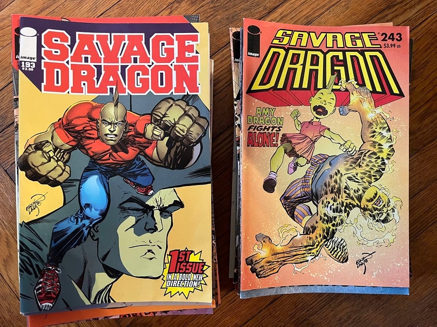Two stacks of comics, the first with Savage Dragon #193 on top, the second with Savage Dragon #243 on top--it's the same pile from before but split in two.