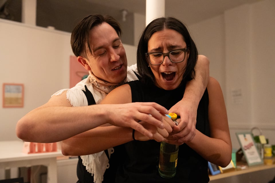 A “Ghost”-like moment of Dan helping Michelle open a bottle.