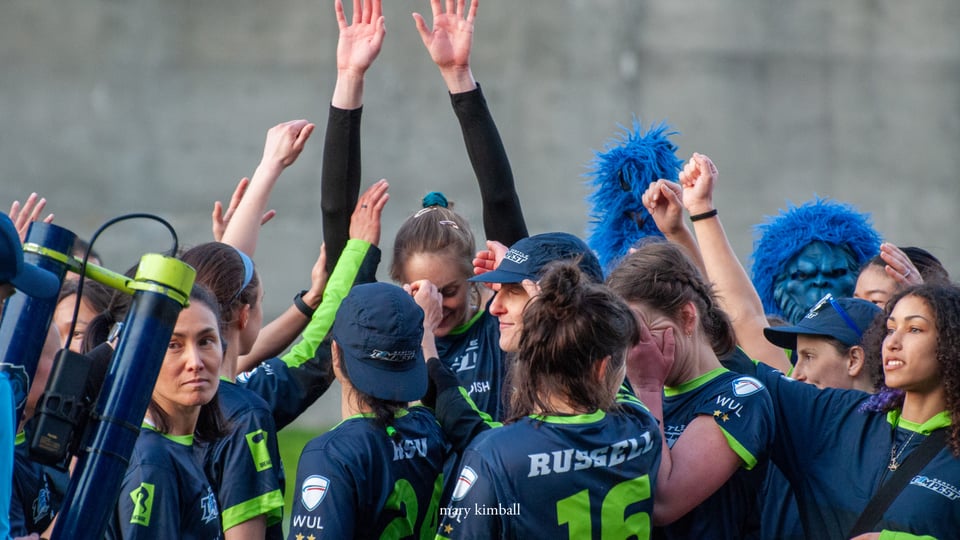 Ultimate team Seattle Tempest celebrates after a win by raising their hands in the hair