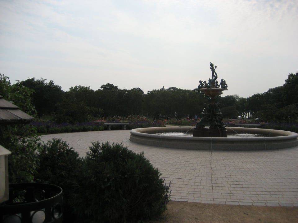 A statue of nymphs in a fountain, in a circular plaza.