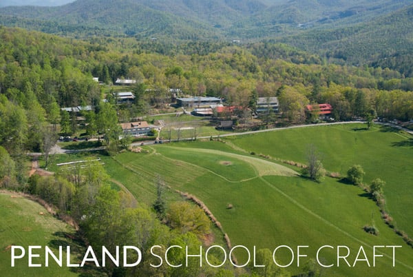 Aerial view of Penland School: a green lawn, cluster of buildings, and green mountains