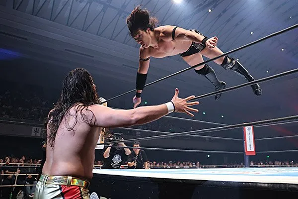 Konosuke Takeshita dives over the ropes on to Yota Tsuji in the G1 Climax tournament.