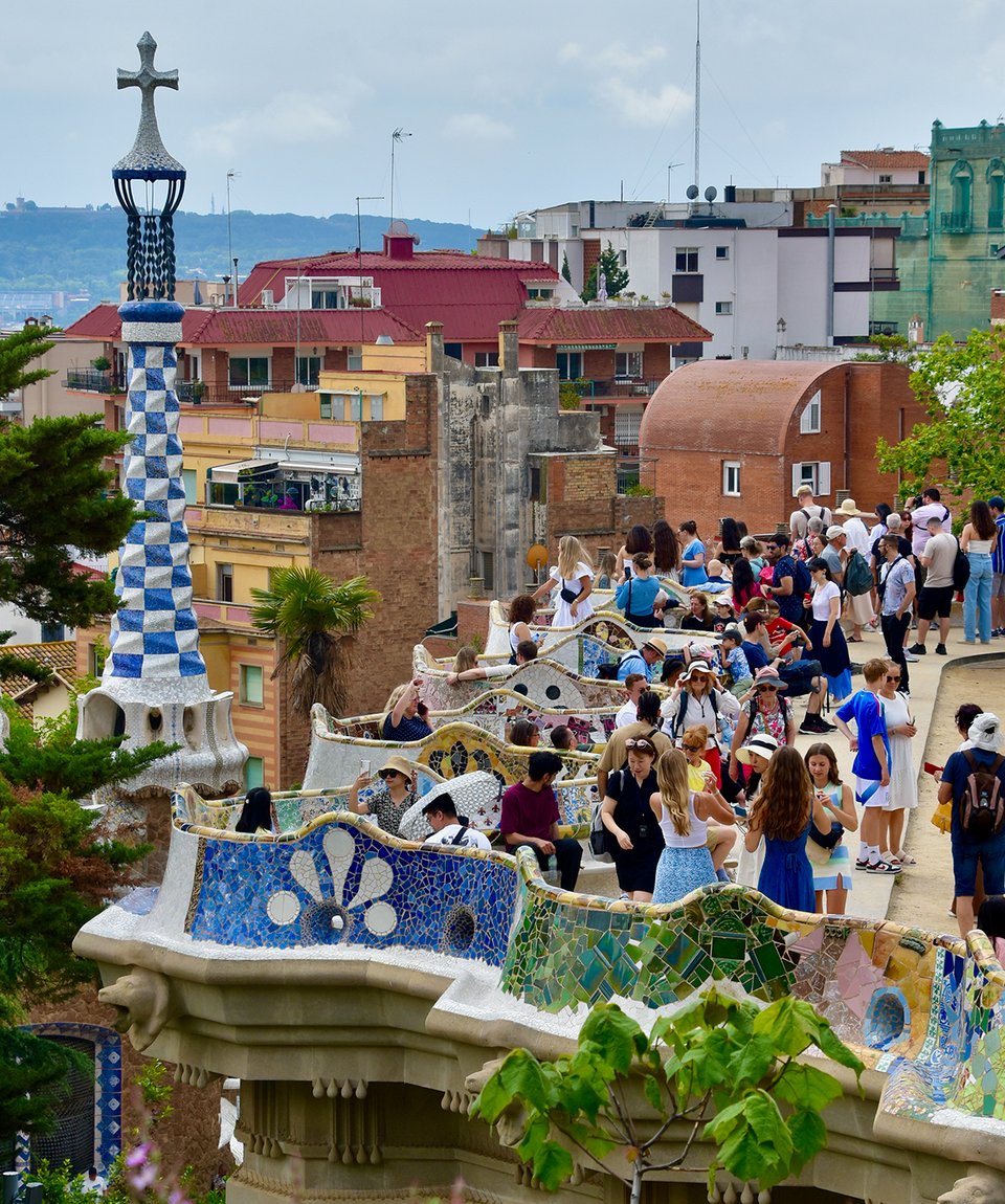 A photo of a color serpentine bench in a public park.