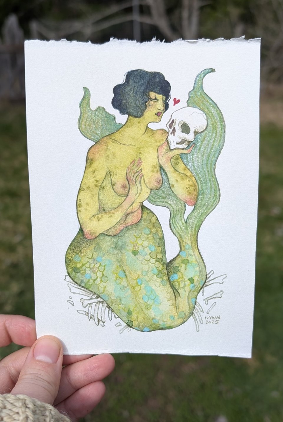 Painting of a mermaid holding a skull