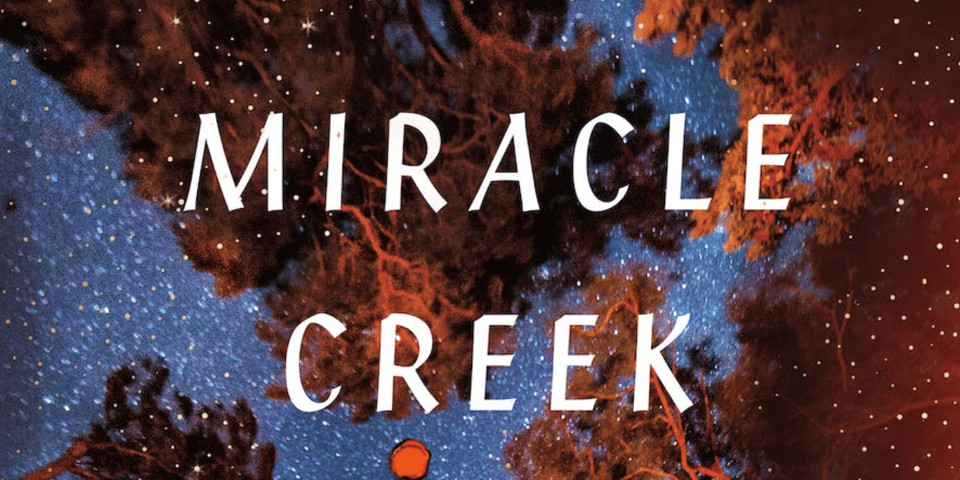 A portion of the cover of "Miracle Creek," featuring the night sky and trees seen from below, along with the novel's title.