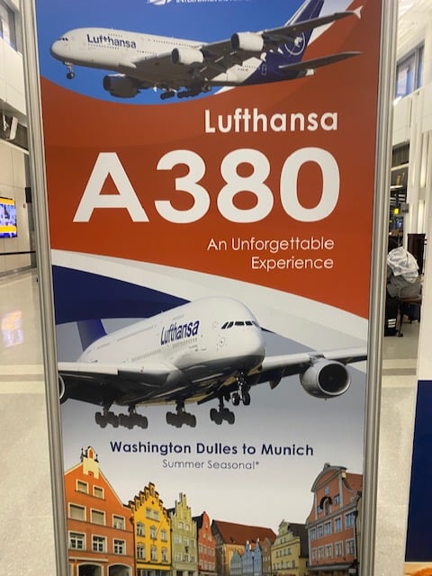 A poster with two photos of the Airbus A380 and one photo of Munich. It says Lufthansa A380, An Unforgettable Experience, Washington Dulles to Muich, Summer Seasonal