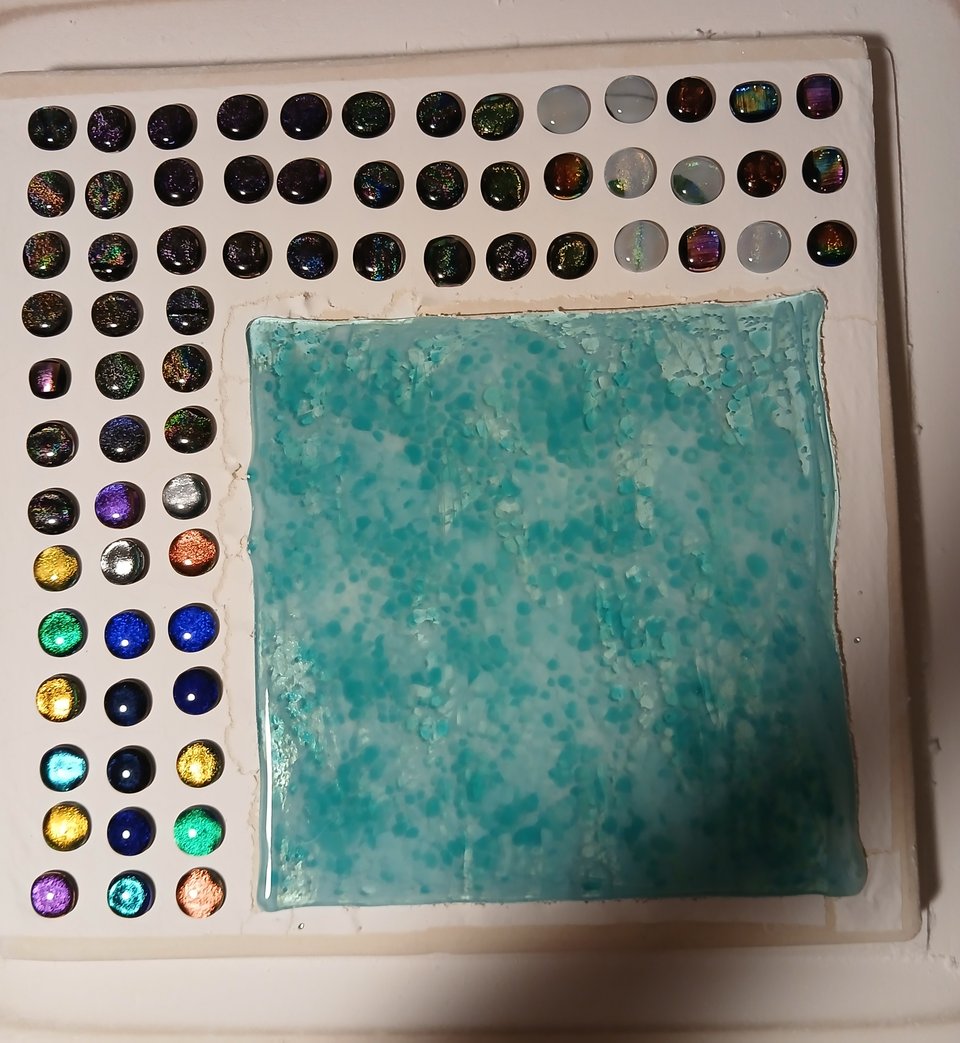 the sheet has melted into a smooth plate, the stacks have rounded into cabochons