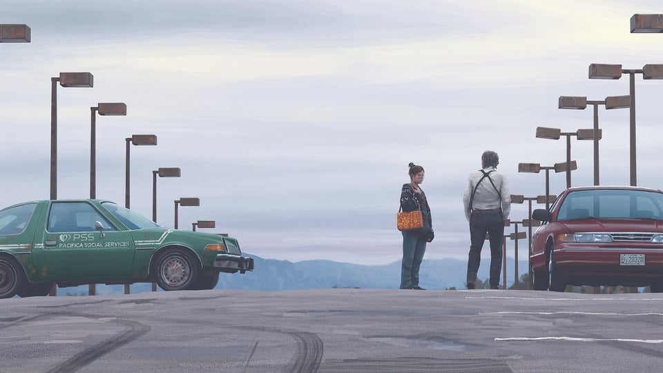 Two lonely travellers are in a parking lot, looking at cars and seem deep in conversation, rows of lights run along each side and it seems as though it is early morning, with mountains visible in the distance through a haze