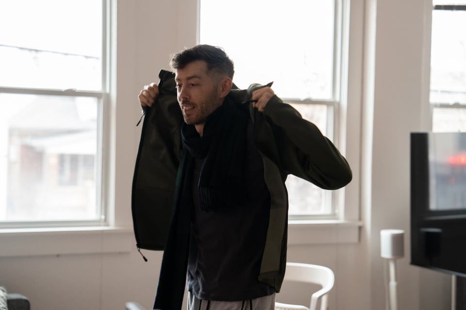 Patrick throwing on a coat.