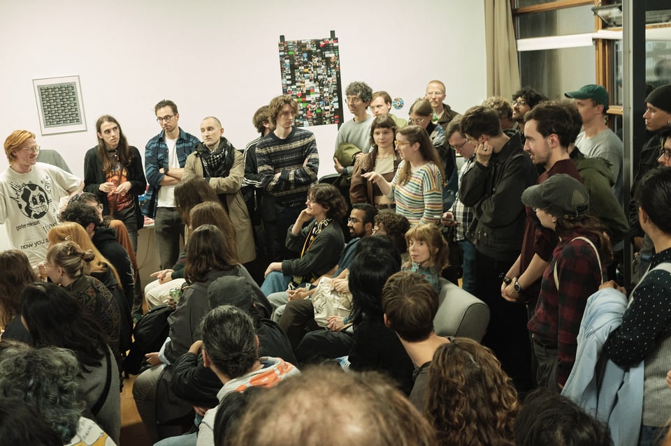 A crowd listens to an audience question