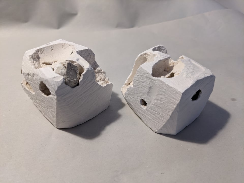 plaster cubes with cavities, some filled with plaster orbs
