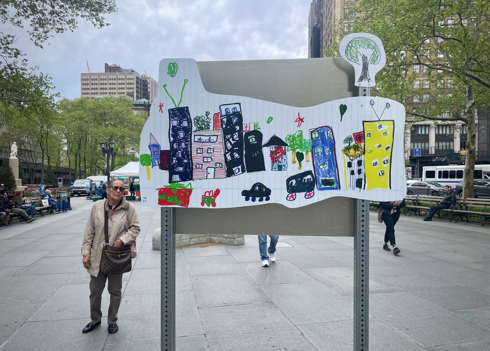 a woman looks at the Public Address exhibit