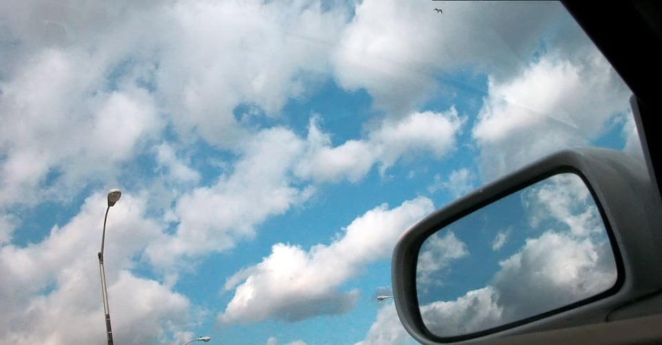 picture of a side view mirror with clouds in it