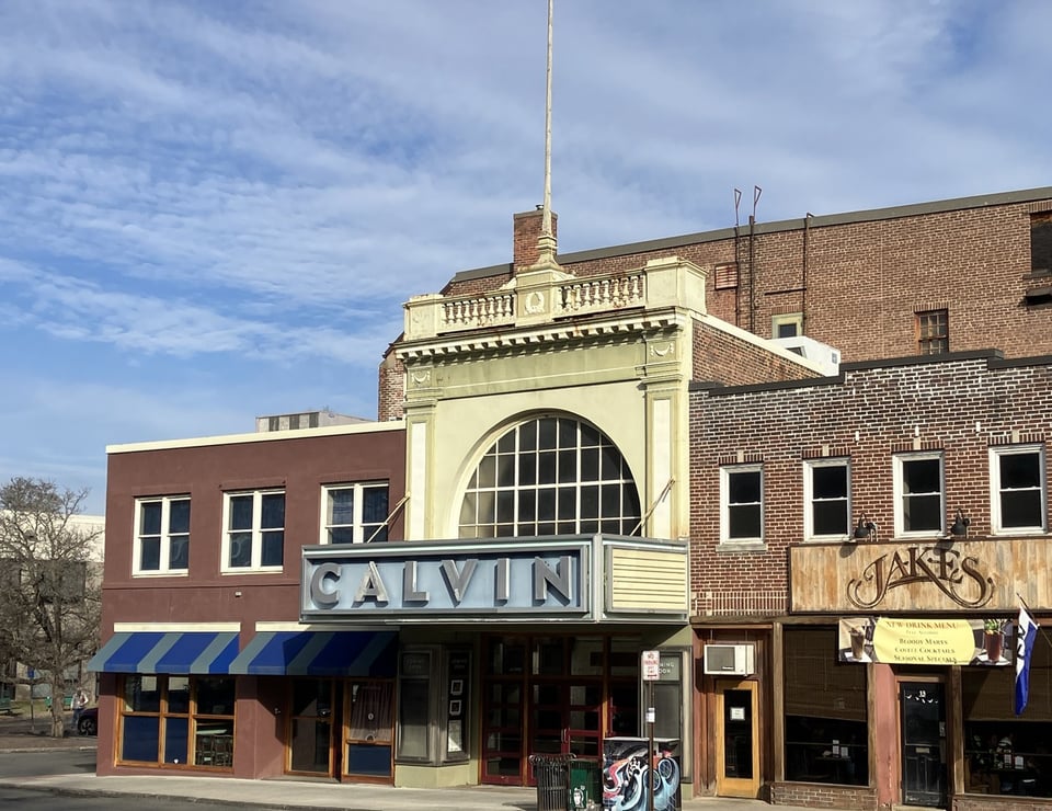 The facade of a 1920s-era theater with the word CALVIN in silver letters on a light-blue marquee.