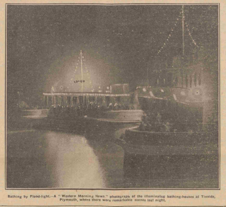 a blurred newsprint photo of nighttime at Tinside. The strings of electric lights can be seen lighting up the 1932 bathing area.