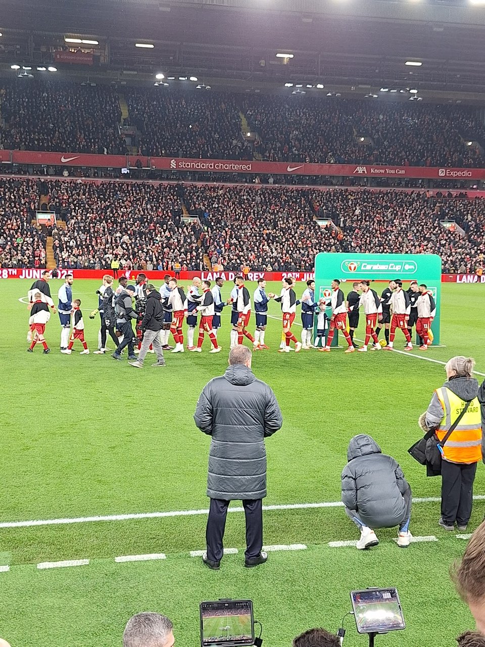 The pre-match handshake at Anfield, Ang Postecoglou in the foreground