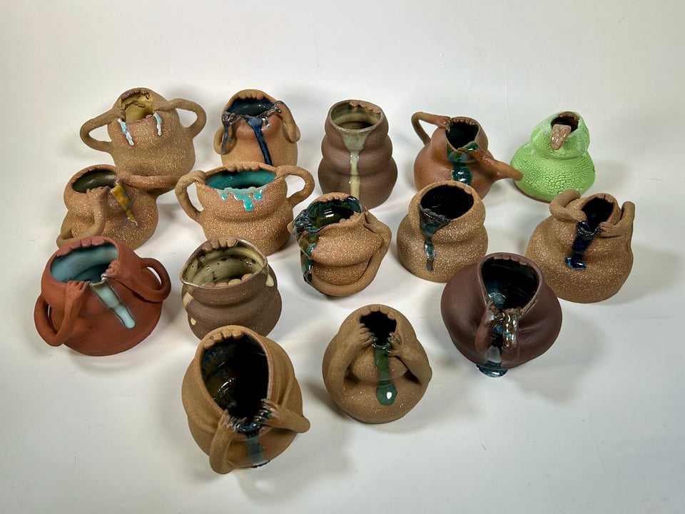 a series of 15 pots that all look like mouths with slime coming out of them