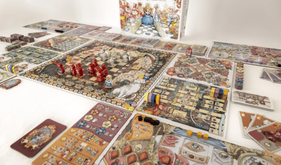 The Queen Alice box and board game components laid out on a white table