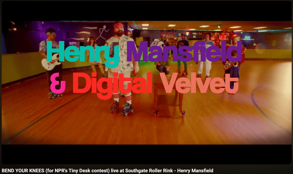Screenshot of a Youtube video: a group of musicians about to start performing while skating at a roller rink. Words: "Henry Mansfield & Digital Velvet"