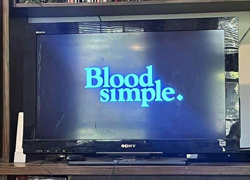 A photo of my television, which in this instant displays the title of the movie Blood Simple.