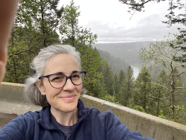 A photo of me posing on a lookout over the Snake River in the rain