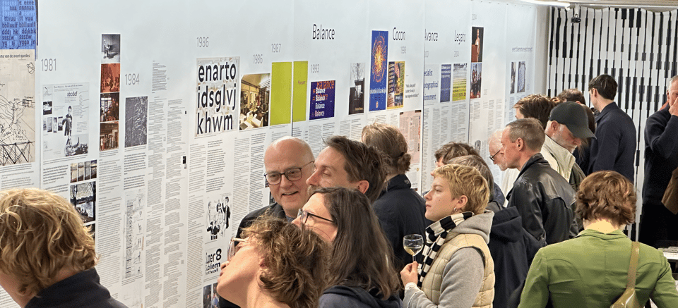 A picture of the opening of the Every Bloemsma exhibition at the enter-enter gallery. On the wall are photos and images, accompanied by a lot of text. Well researched.