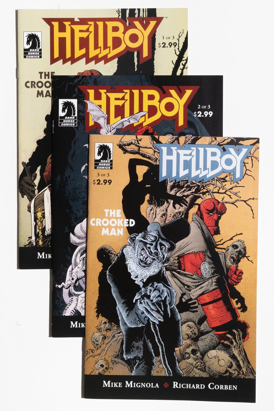 The three issues of Hellboy: The Crooked Man stacked diagonally on each other. Issue 3 is on the top. Art by Richard Corben.