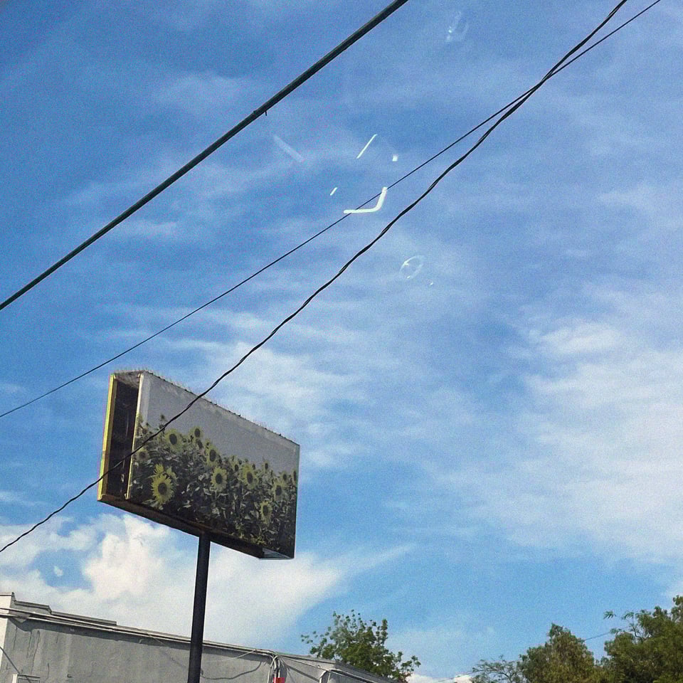 a sunflower billboard against a beautiful blue sky in california