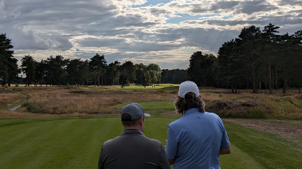 Friends, Cennydd and Simon, stood together on a tee box, discussing how to tackle the hole in front at Woodhall Spa Hotchkin
