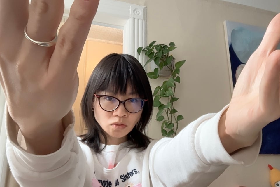 ohyung gesticulating outward in front of her web cam