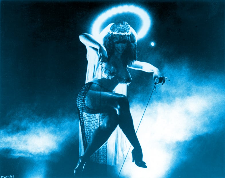 A gigantic, scantily clad woman smiling with a halo about her head. She's pinching two long ropes between her fingers, but these represent the mooring ropes for a hot-air balloon. This is the final scene from Fellini's 'City of Women.'